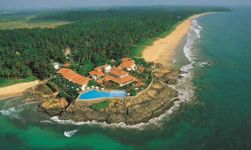 Stay in a large hotel with a beach